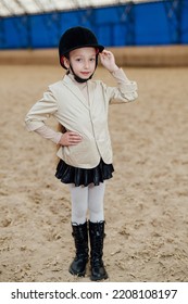 Cute Girl In Jockey Cap. Prepairing For Horse Riding.