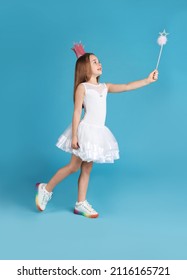 Cute Girl In Pink Crown With Magic Wand On Light Blue Background. Little Princess