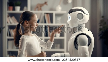 A cute girl is playing with a robot. The concept of future training.
