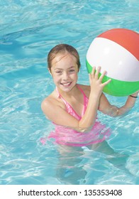 Cute Girl Playing In A Swimming Pool