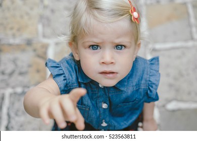 Cute Girl Reaching Finger To Camera, Pointing.