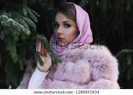 A cute girl in a rose pashmina and rose fur coat