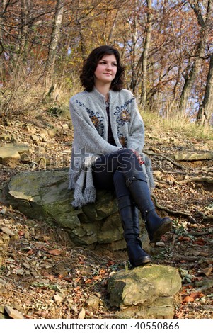 Cute girl sitting in the forest