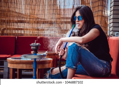 Cute Girl Smoking Shisha Outside In A Bar