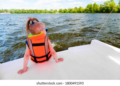 Cute girl in sunglasses wearing buoyancy aid enjoying her summer vacation on paddle-boat. - Shutterstock ID 1800491593