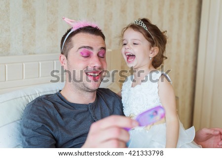 Similar – Lachendes, fröhliches Mädchen zieht dicke Hornbrille; Scherzartikel mit hoher Dioptrin aus Spaß, Verkleidung und Freude, an Karneval; Fasching an und lacht dabei fröhlich in die Kamera.