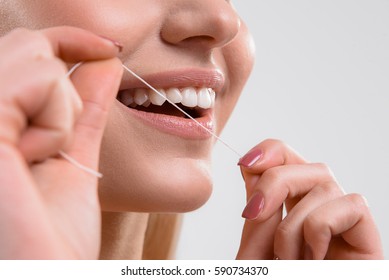 Cute Girl Using Dental Floss