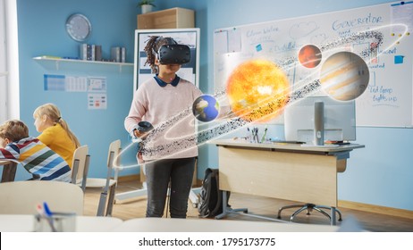 Cute Girl Wearing Augmented Reality Headset and Using Controllers Interacts with 3D Solar System. Futuristic School Science Class for Children Learning in STEM Programs. VFX, Special Effects Render