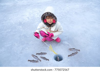 Cute Girls Are Sitting On The Floor Of Ice Fishing. Ice Fishing Tournament. Ice Fishing Travel At The North Pole. Ice Fishing Tour At Antarctica.