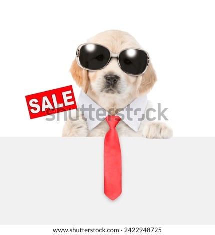 Cute Golden retriver puppy wearing sunglasses and necktie shows signboard with labeled "sale" above empty white banner. isolated on white background