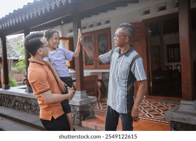 cute grandchild high five her asian grandfather, family concept - Powered by Shutterstock