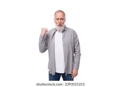 a cute grandfather with a white beard and mustache is wearing a striped shirt over a t-shirt - Shutterstock ID 2393521215