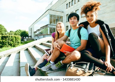 cute group of teenages at the building of university with books huggings, diversity nations students lifestyle
