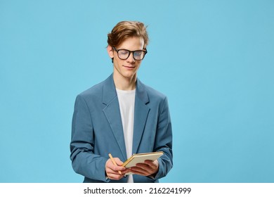 Cute Guy In Glasses And A Classic Suit Takes Notes In A Notebook