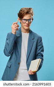 Cute Guy In Glasses And A Classic Suit Takes Notes In A Notebook