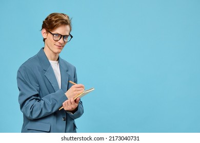 Cute Guy In Glasses And A Classic Suit Takes Notes In A Notebook