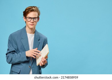 Cute Guy In Glasses And A Classic Suit Takes Notes In A Notebook