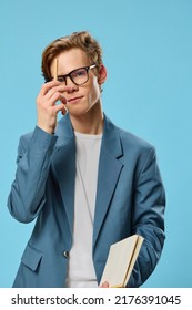 Cute Guy In Glasses And A Classic Suit Takes Notes In A Notebook