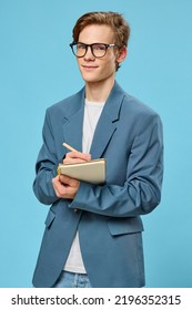 Cute Guy In Glasses And A Classic Suit Takes Notes In A Notebook