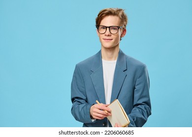 Cute Guy In Glasses And A Classic Suit Takes Notes In A Notebook