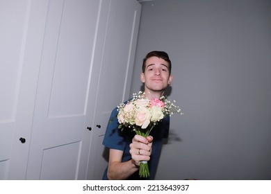 Cute Guy Holding A Bouquet Of Flowers In His Hands