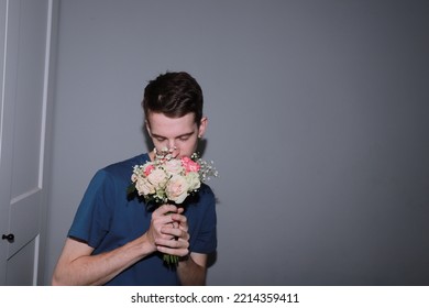 Cute Guy Holding A Bouquet Of Flowers In His Hands