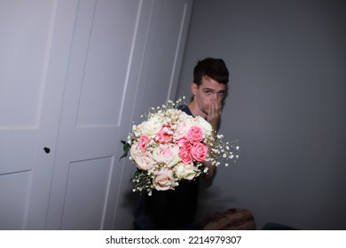 Cute Guy Holding A Bouquet Of Flowers In His Hands