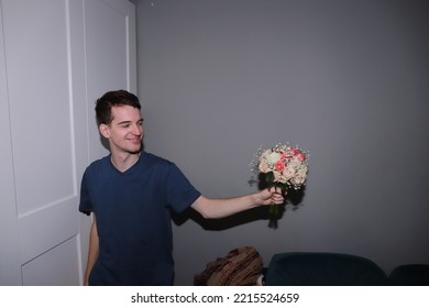 Cute Guy Holding A Bouquet Of Flowers In His Hands