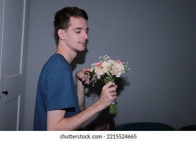 Cute Guy Holding A Bouquet Of Flowers In His Hands