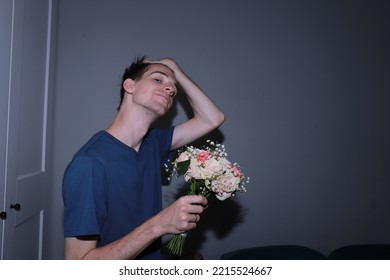 Cute Guy Holding A Bouquet Of Flowers In His Hands