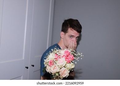 Cute Guy Holding A Bouquet Of Flowers In His Hands