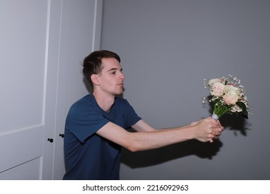 Cute Guy Holding A Bouquet Of Flowers In His Hands