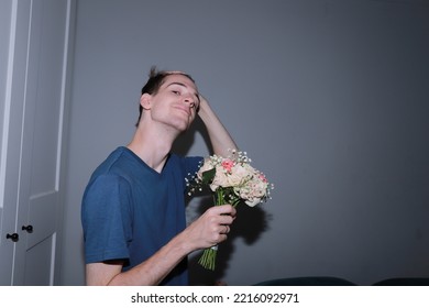 Cute Guy Holding A Bouquet Of Flowers In His Hands