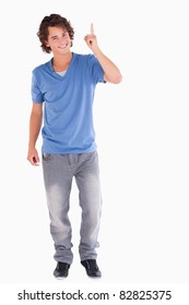 Cute guy pointing at copyspace in a studio