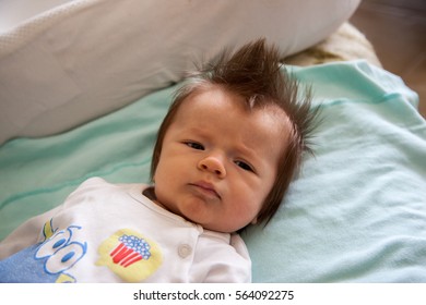 Cute Hairy Baby Boy Is Lying On The Bed And Looking Interested Somewhere