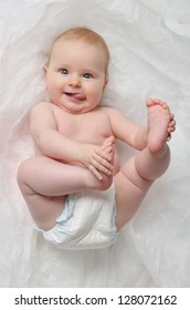  Cute Happy 7 Month  Baby Girl In Diaper Lying And Playing