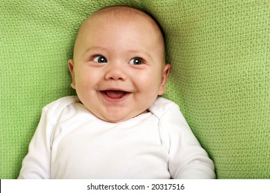 Cute Happy Baby Boy Smiling on green background