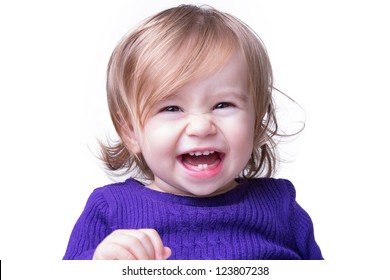 Cute happy baby is laughing fearless and freely with her new teeth, looking in to camera. Isolated on white.