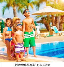 Cute Happy Family Having Fun Near Pool On Luxury Tropical Resort, Mother With Children Looking Up In Sky, Summer Holidays, Love Concept