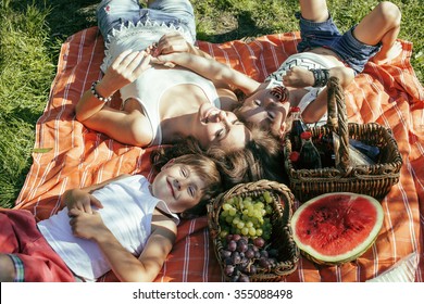 Cute Happy Family On Picnic Laying On Green Grass Mother And Kids, Warm Summer Vacations Close Up, Brother And Sister