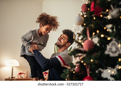 Cute happy girl playing with daddy at home. - Powered by Shutterstock