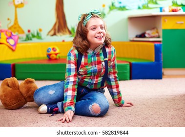 Cute Happy Girl Playing In Kindergarten For Kids With Special Needs