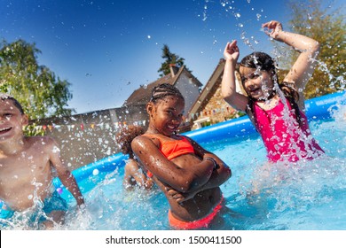 Cute happy girl pose with friends in the pool - Powered by Shutterstock