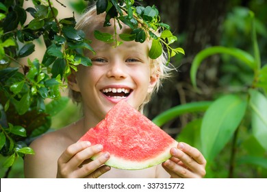 Cute Happy Kid Eating Watermelon In Summertime In The Garden