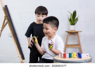 Cute Happy Little Asian Boy Painting With Watercolor On Canvas Standing In The White Room At Home, Creative Young Artist At Work. Kids Paint. Children Draw.