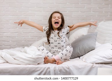 Cute Happy Little Child Girl In Pyjamas In Bed. Good Morning