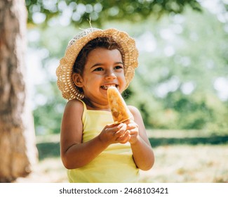 Cute happy little girl in yellow dress and hat eating fruit ice cream. Summer fun child playing in park. Summertime vibrant color background. - Powered by Shutterstock