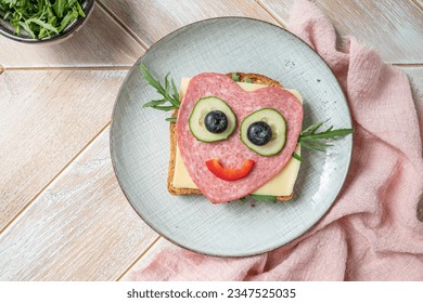 Cute heart shape sandwich with salami and cheese
