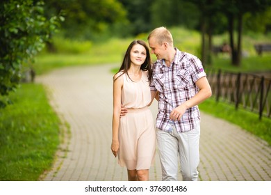 Cute Hip Couple Walking Hand In Hand In A Park - Romantic Date Outdoors