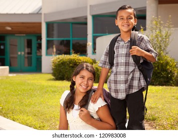 Cute Hispanic Brother And Sister Wearing Backpacks Ready For School.